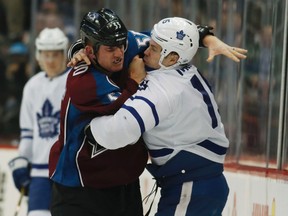 Avalanche left wing Cody McLeod (left) fights with Maple Leafs left wing Matt Martin during NHL action in Denver on Dec. 22, 2016. The Avs traded McLeod on Friday to the Predators in exchange for forward Felix Girard. (AP Photo/David Zalubowski)