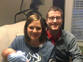 In the photo taken Dec. 24, 2016, by Luke Gardner with his cellphone on a timer, Luke and Hillary Gardner pose with their son Cade Lee in Baldwyn, Miss. (Luke Gardner via AP)