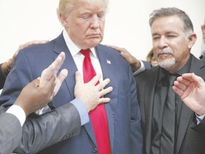 Pastors from the Las Vegas area pray with Republican presidential candidate Donald Trump during the U.S. presidential campaign. Douglas Todd asks if a Trump-like candidate could win favour among Canadian evangelicals. (Evan Vucci/AP Photo)