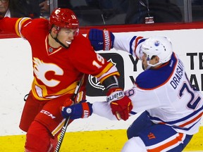 Edmonton Oilers Connor McDavid battles for the puck against Sean Monahan of the Calgary Flames during NHL hockey in Calgary, Alta., on Friday, October 14, 2016. The two teams meet again Saturday with playoff implications on the line.