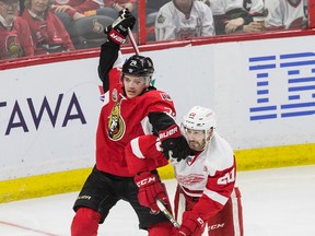 Ottawa Senators defenceman Mark Borowiecki checks Detroit Red Wings left wing Drew Miller during NHL action at Canadian Tire Centre on Dec. 29, 2016. (Errol McGihon/Postmedia)