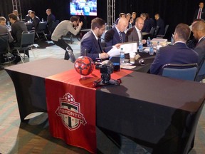 Toronto FC’s braintrust talk things over before selecting Notre Dame defender Brandon Aubrey (inset) in yesterday’s SuperDraft. (THE CANADIAN PRESS)