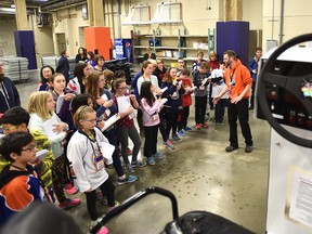 Jason Rimmer (R), assistant manager of engineering, describes one of their zambonis to grade six Holyrood School students at the Ice School where students have the opportunity to interview and hear from different staff members at Rogers Place in Edmonton, Friday, January 13, 2017. Ed Kaiser/Postmedia News