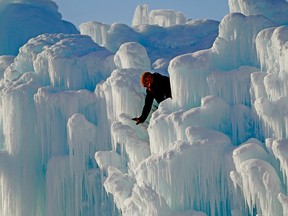 Cory Livingood, lead artisan for the Ice Castles at Hawrelak Park in Edmonton, inspects the exhibit on Jan. 12, 2016. Edmonton may be a winter city, but its visitor information centre is closed until spring. Larry Wong/Postmedia News