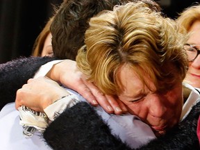 Prime Minister Justin Trudeau hugs an emotional Kathy Katula, from Buckhorn at a packed banquet hall at the Evinrude Centre in Peterborough, Ont., at a town hall meeting on Friday Jan. 13, 2017. (Clifford Skarstedt/Postmedia Network)