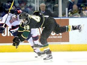After missing six weeks, London Knights forward Max Jones wasted no time making his presence felt as he unloads on Max Grondin of the Saginaw Spirit during the first period of their OHL game at Budweiser Gardens on Friday night. (MIKE HENSEN, The London Free Press)