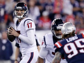 In this Sept. 22, 2016, file photo, Houston Texans quarterback Brock Osweiler looks to pass as New England Patriots defensive end Chris Long rushes during the first half of an NFL football game in Foxborough, Mass. (AP Photo/Charles Krupa, File)