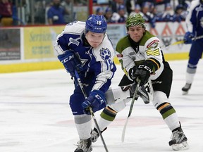 Macauley Carson, left, of the Sudbury Wolves, and Adam McMaster, of the North Bay Battalion, battle for the puck during OHL action at the Sudbury Community Arena in Sudbury, Ont. on Friday January 13, 2017. John Lappa/Sudbury Star/Postmedia Network