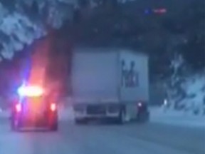 A California Highway Patrol officer filmed a big rig that had jackknifed at the top of a slippery highway do a controlled slide about a mile downhill until the next exit. (Facebook screengrab)