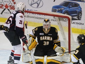 Cole Purboo of the Windsor Spitfires watches a shot deflect up in the air over Sarnia Sting goalie Aidan Hughes during the Ontario Hockey League game at Progressive Auto Sales Arena on Friday, Jan. 13, 2017 in Sarnia, Ont. (Terry Bridge/Sarnia Observer)