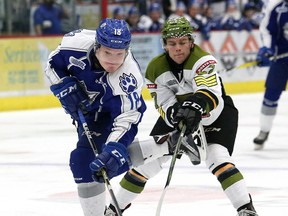 Macauley Carson, left, of the Sudbury Wolves, and Adam McMaster of the North Bay Battalion battle for the puck during OHL action at the Sudbury Community Arena in Sudbury, Friday.
John Lappa/Postmedia Network