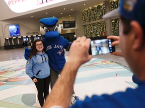Breanna Winegarden (left), 12, gets a photo taken by her father Charles with Blue Jays mascot Ace before meeting Toronto Blue Jays players Kevin Pillar, Devon Travis, Aaron Sanchez and Marco Estrada during a Blue Jays 2017 Winter Tour stop at Rogers Place in Edmonton, Alberta on Friday, January 13, 2017. Ian Kucerak/Postmedia News