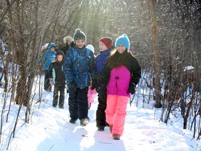 Bassett Lawang (L), Brian Spencer (red hat) and Ferni Jimenez (R), grade 5 students of Regina Street Public School in Ottawa, are one of the many fortunate to have access to Mud Lake as part of their learning curriculum.  The school is facing closure. Jean Levac / Ottawa Sun