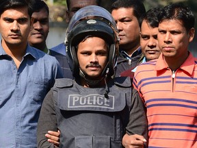 Bangladesh police escort alleged Islamist militant Jahangir Alam (C) in Dhaka on Jan. 14, 2017, after his arrest in connection with an attack on the Holey Artisan Bakery attack last year. (STR/AFP/Getty Images)
