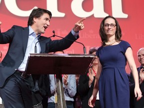 Federal Liberal leader Justin Trudeau and newly elected president Anna Gainey take the stage at the party's biennial convention February 22, 2014 in Montreal. (THE CANADIAN PRESS/Ryan Remiorz)
