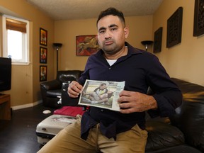 Elias Malkum holds a photo of his brother-in-law Leonardo Duran Ibanez while posing for a photo at his home in Edmonton, Alberta on Wednesday, November 16, 2016. IAN KUCERAK / POSTMEDIA