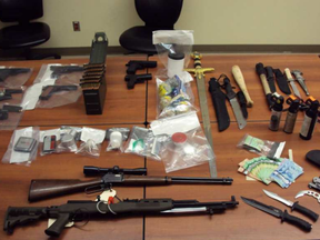 Six people are facing charges after guns, drugs and cash were uncovered during searches in Hinton, Alta.