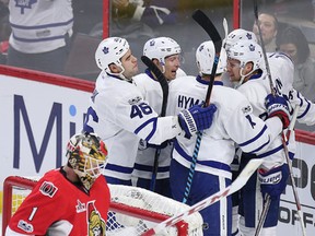 Ottawa goalie Mike Condon bows his head while the Maple Leafs celebrate a goal against the Senators during an NHL game at Canadian Tire Centre on Jan. 14, 2017. (Wayne Cuddington/Postmedia)