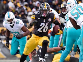 In this Jan. 8, 2017, file photo, Pittsburgh Steelers running back Le'Veon Bell runs during an AFC Wild Card NFL game against the Miami Dolphins in Pittsburgh. (AP Photo/Don Wright, File)