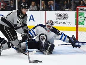 Los Angeles Kings center Nick Shore, left, tires to get a shot in on Winnipeg Jets goalie Michael Hutchinson during the second period of an NHL hockey game, Saturday, Jan. 14, 2017, in Los Angeles. (AP Photo/Mark J. Terrill)