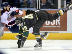Max Jones wasted no time making his presence felt as he unloads on Saginaw's Max Grondin in the first period of their game at Budweiser Gardens on Friday. Mike Hensen/The London Free Press/Postmedia Network  
Mike Hensen