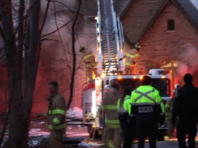 Sarnia firefighters continue to work a fire at a home in the 1600 block of Lakeshore Road Saturday evening. Residents escaped the fire but one man suffered burn injuries.NEIL BOWEN/Sarnia Observer