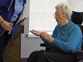 Megan McKever, Girl Guides administrative community leader for the local area, presents Betty McAskill, 101, with her 85-year pin Saturday afternoon at Trillium Retirement and Care Community. (Steph Crosier/The Whig-Standard)