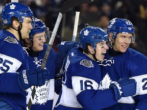Toronto Maple Leafs centre Mitch Marner celebrates his goal with teammates James van Riemsdyk, Tyler Bozak and Nikita Zaitsev during third period NHL Centennial Classic hockey action against the Detroit Red Wings, in Toronto on Sunday, January 1, 2017. (THE CANADIAN PRESS/Frank Gunn)