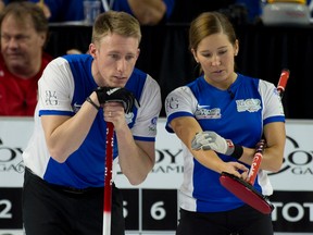 Team North America  Marc Kennedy of Edmonton and  Kaitlyn Lawes of Winnipeg look at their options during mixed doubles competition at the World Financial Group Continental Cup of Curling in Las Vegas on Saturday, Jan. 14, 2014. (Curling Canada)