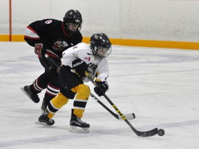 Cole Hannon of the Mitchell Pee Wee AE’s breaks out of the Listowel zone while being chased during second period action of Game 1 in their OMHA Group 3-4 AE playoff series last Friday, Jan. 13. Hannon was the lone scorer in a 1-0 win. Listowel edged the Meteors 2-1 in Game 2 last Sunday. ANDY BADER MITCHELL ADVOCATE