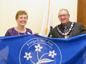 To recognize Alzheimer Awareness Month in West Perth, Sheri Gihula, the public education coordinator for the Alzheimer Society of Perth County, presented Mayor Walter McKenzie with the Alzheimer Awareness flag Jan. 9, which will be hoisted up the flagpole at the information booth in Mitchell and will stay there for the month. GALEN SIMMONS MITCHELL ADVOCATE