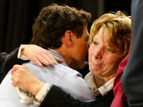 Prime Minister Justin Trudeau hugs an emotional Kathy Katula, from Buckhorn at a packed banquet hall at the Evinrude Centre in Peterborough, Ont., on Friday Jan. 13, 2017. (Clifford Skarstedt/Postmedia Network)