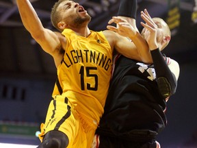 London Lightning?s Garrett Williamson is fouled by Windsor?s Nick Evans as he drives to the hoop during their National Basketball League of Canada game at Budweiser Gardens on Sunday. (MIKE HENSEN, The London Free Press)