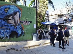 Police guard the entrance of the Blue Parrot nightclub in Playa del Carmen, Mexico on Monday. A deadly shooting occurred in the early morning hours outside the nightclub while it was hosting part of the BPM electronic music festival, according to police. (AP Photo)