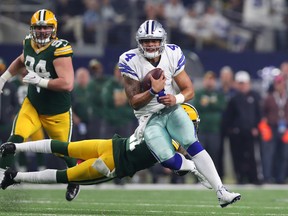 Dak Prescott of the Dallas Cowboys carries the ball against the Green Bay Packers in the NFC Divisional Playoff game at AT&T Stadium on Jan. 15, 2017. (Tom Pennington/Getty Images)