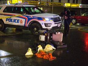 A forensics officer from the London police photographs the scene of a collision at Dundas and Adelaide Street on Monday January 16, 2017.  Mike Hensen/The London Free Press/Postmedia Network