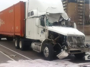 A damaged transport truck is shown in this Lambton OPP photo, via Twitter, following a collision Monday afternoon on Highway 402 near Christina Street in Sarnia. A Brampton resident has been charged with careless driving (Handout)