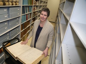 Jason Miller/The Intelligencer
Archivist Amanda Hill showcases, circa 1800s, Hastings County tax records acquired since the Community Archives of Belleville and Hastings County moved into its new home at the Belleville Public Library last year.