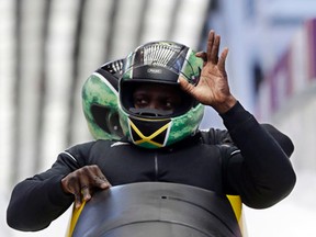 The team from Jamaica, piloted by Winston Watts, brake in the finish area during the men's two-man bobsled training at the 2014 Winter Olympics in Krasnaya Polyana, Russia, on Feb. 13, 2014. (Dita Alangkara/AP Photo/Files)