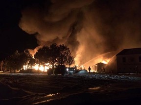 Firefighters attempt to put out a blaze in Milltown, NL. (Rene Jeddore/Facebook)