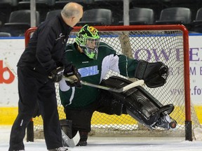 London Knights goaltender coach Dave Rook shoots on goaltender Tyler Parsons during practice at the Budweiser Gardens on Tuesday. (Morris Lamont/The London Free Press)