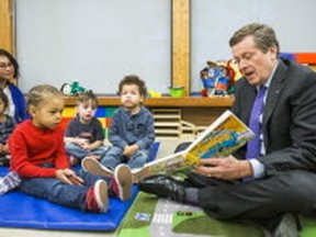 Toronto Mayor John Tory reads to children at the Dane Avenue Childcare Centre in Toronto on Tuesday. (ERNEST DOROSZUK, Toronto Sun)
