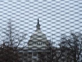 The US Capitol is seen through a security fence Tuesday placed in preparation for inauguration of President-elect Donald Trump in Washington, DC. (Brendan Smialowski/AFP/Getty Image)
