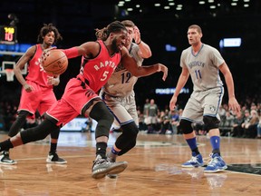 Raptors forward DeMarre Carroll (5) drives against Nets forward Joe Harris (12) during first quarter NBA action in New York on Tuesday, Jan. 17, 2017. (Julie Jacobson/AP Photo)