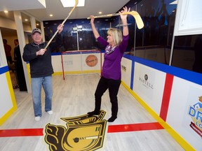 Former London Knight John Held and his wife, Brenda, celebrate Wednesday in the basement hockey ?rink? after winning the Dream Lottery grand prize home. The fully furnished north London residence features a Knights-themed recreation room. (MORRIS LAMONT, The London Free Press)