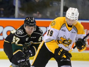 Mitchell Stephens of the Knights picks the pocket of Ryan McGregor of the Sarnia Sting during the first period of their game Wednesday night at Budweiser Gardens in London, Ont. (MIKE HENSEN, The London Free Press)