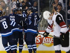 The Jets celebrate a goal against the Coyotes on Wednesday. (JOHN WOODS/Canadian Press)