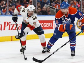 Jaromir Jagr races Oilers defenceman Adam Larsson for the puck during Wednesday's game at Rogers Place. (Ian Kucerak)