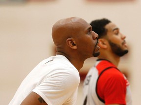 Jerry Stackhouse (left) works with Corey Joseph of the Raptors during a practice on May 20, 2016. (MICHAEL PEAKE/Toronto Sun files)