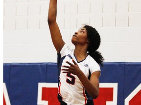 Christine Madago of the Loyalist Lancers serves during Wednesday night's OCAA women's volleyball game vs. Fleming at Loyalist College. (Loyalist Athletics photo)